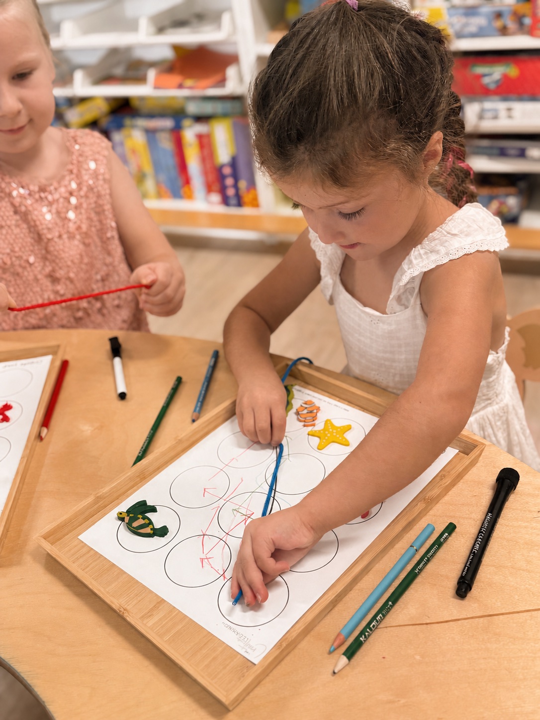 Children practicing pencil control and matching during a Kindergarten Readiness activity