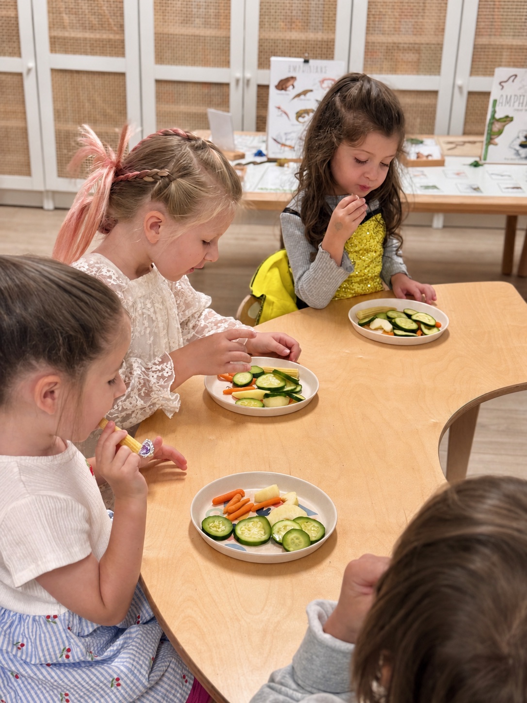 Children sharing a nourishing snack together at Foxville Kids