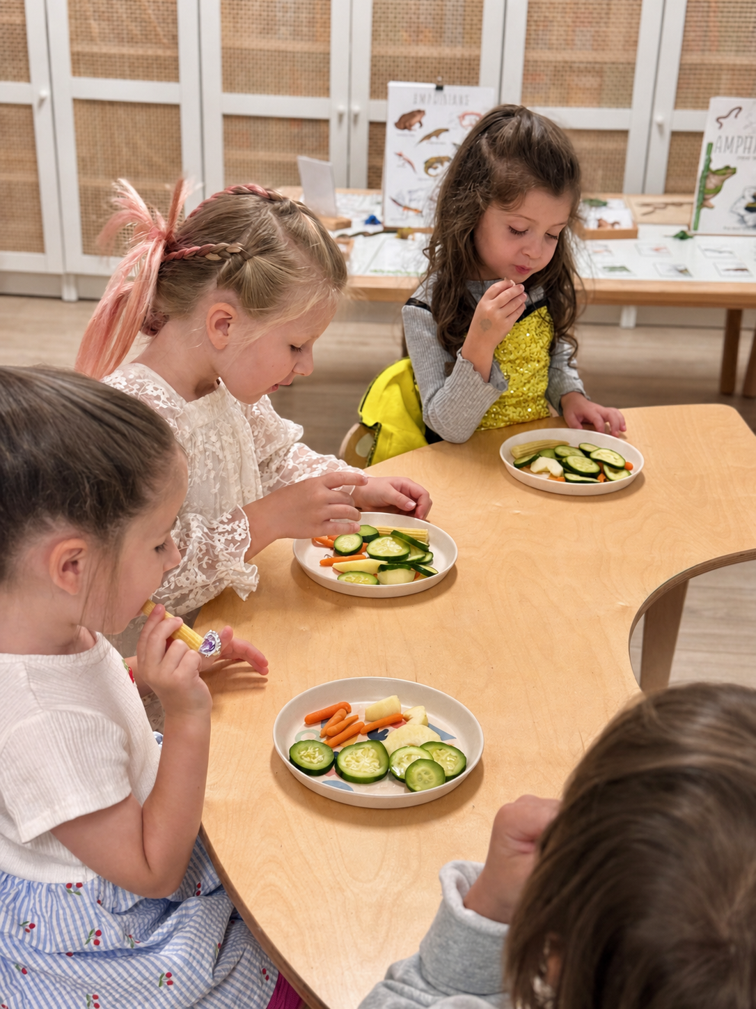 Children sharing a nourishing snack together at Foxville Kids