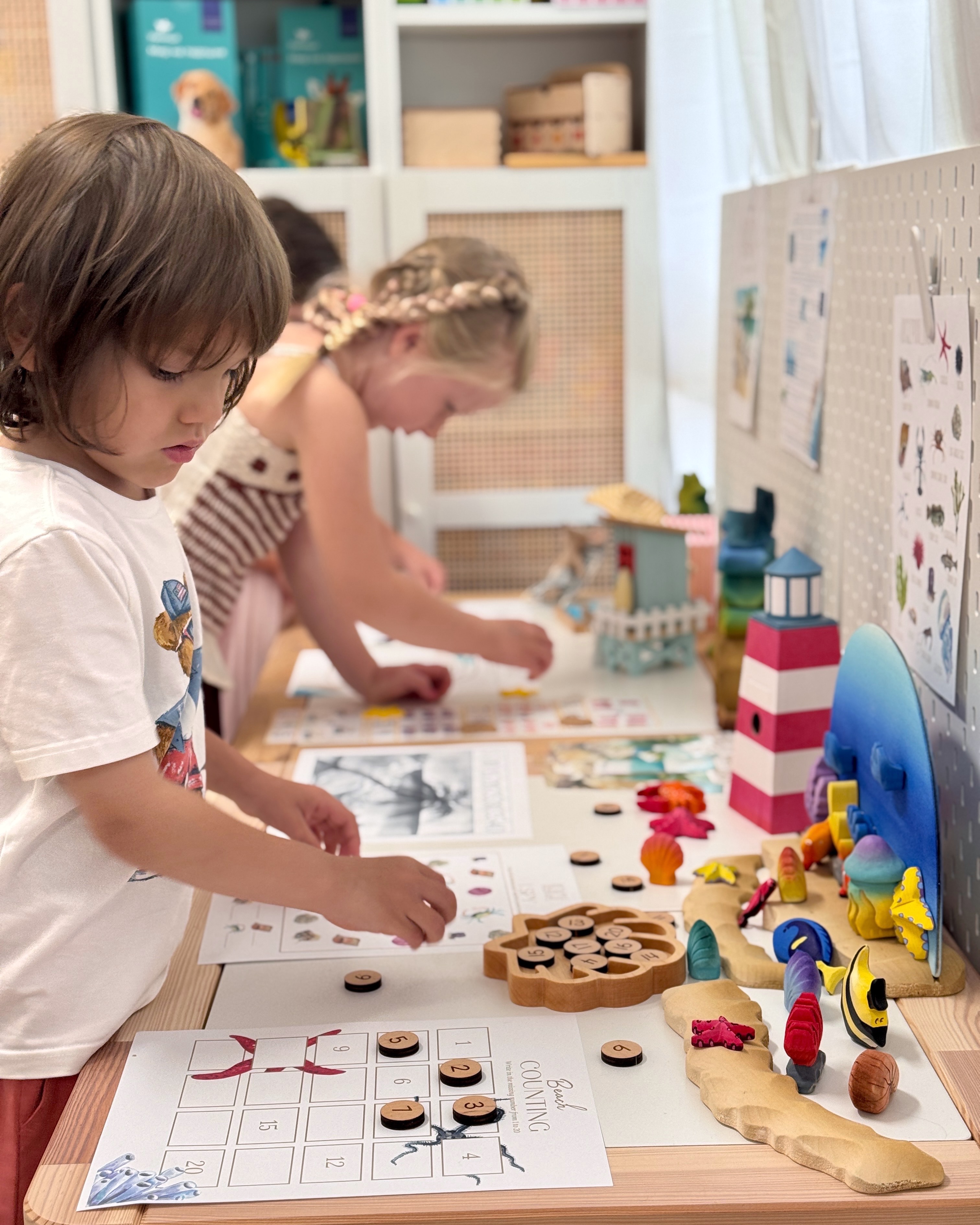 Children exploring a themed hands-on learning invitation during an enrichment class