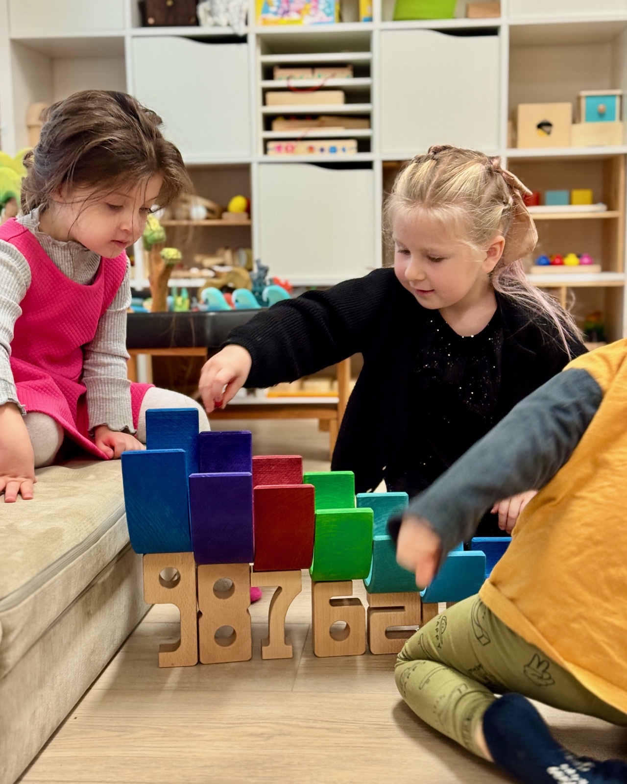 Children collaborating with colorful open-ended building materials