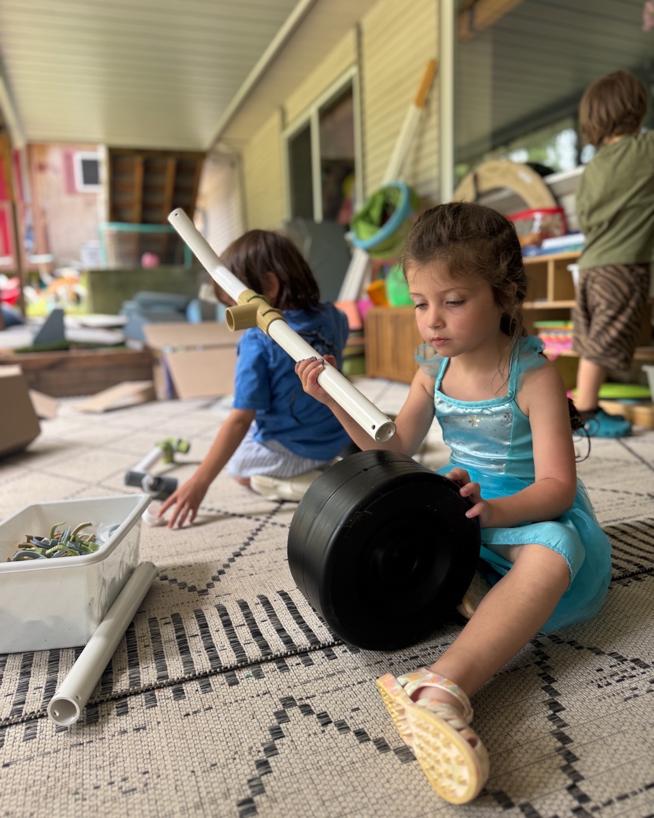 A child creating with open-ended construction materials during Summer Camp